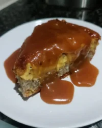 slice of banana pudding poke cake showing pudding channels