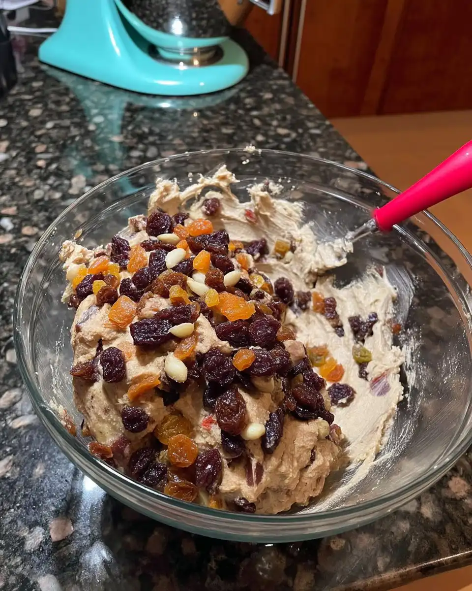 Chocolate Fruit Cake 13 Whisking hot water into cocoa powder and chocolate in a bowl
