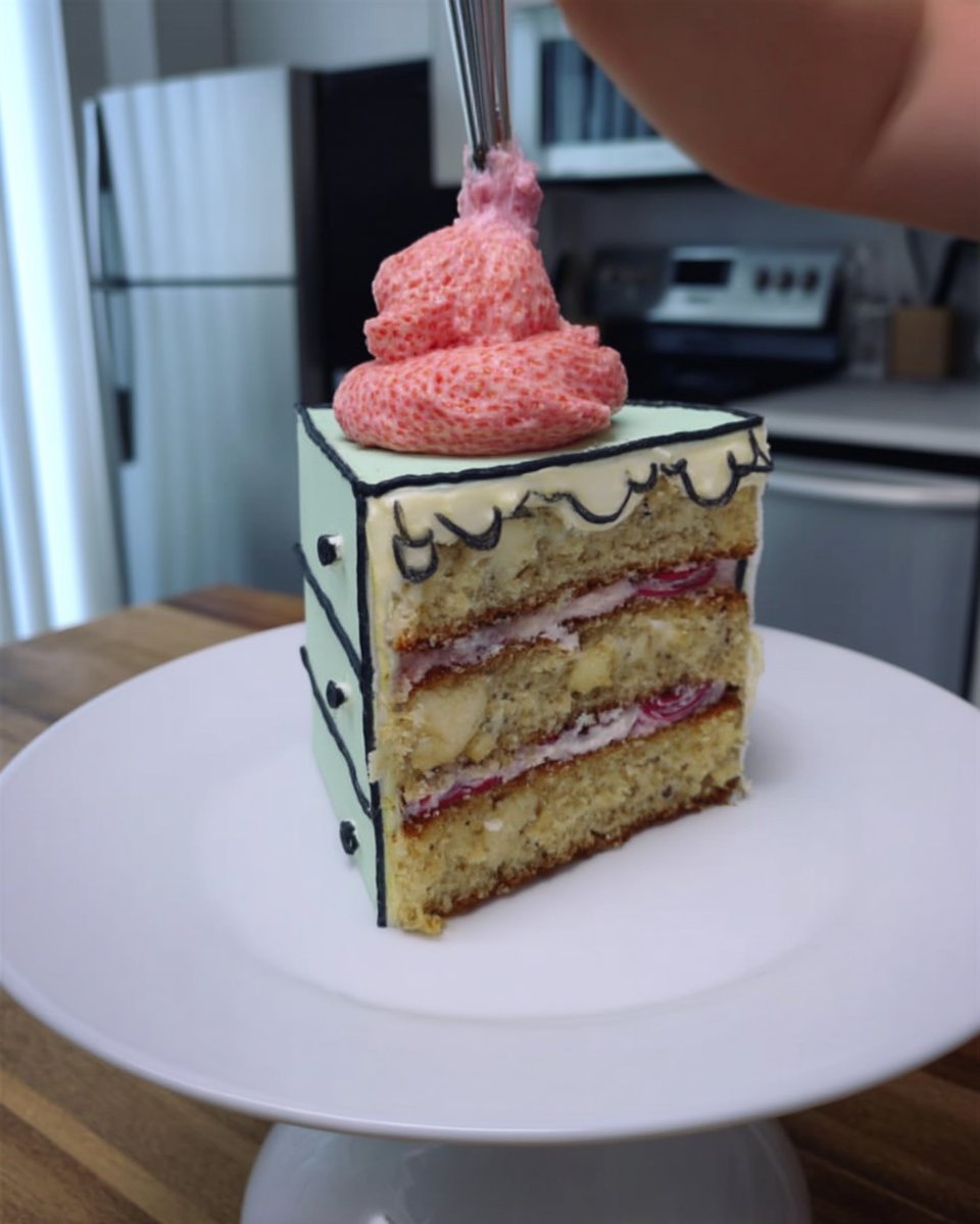 Comic Cake (2D Cake) 14 Finished 2D comic cake slice served on a white plate