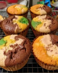 Colorful cute cake cupcakes with vanilla frosting on a tiered stand