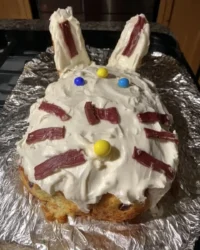 Speckled blue Easter cake with coconut nest and pastel eggs