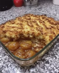 Slice of fresh peach cake on a white plate showing moist crumb