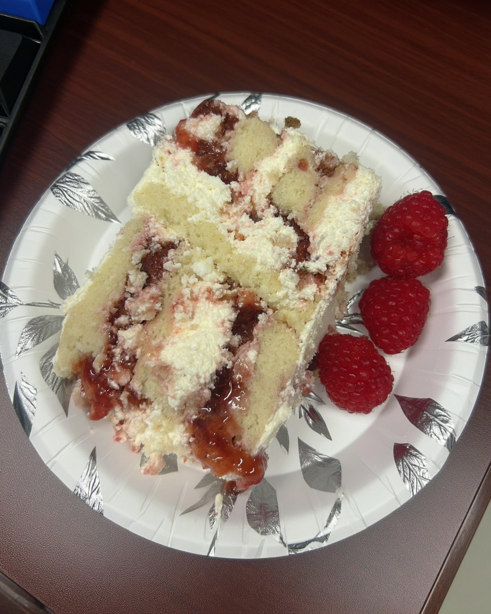 Whole frosted raspberry white chocolate cake with fresh berries