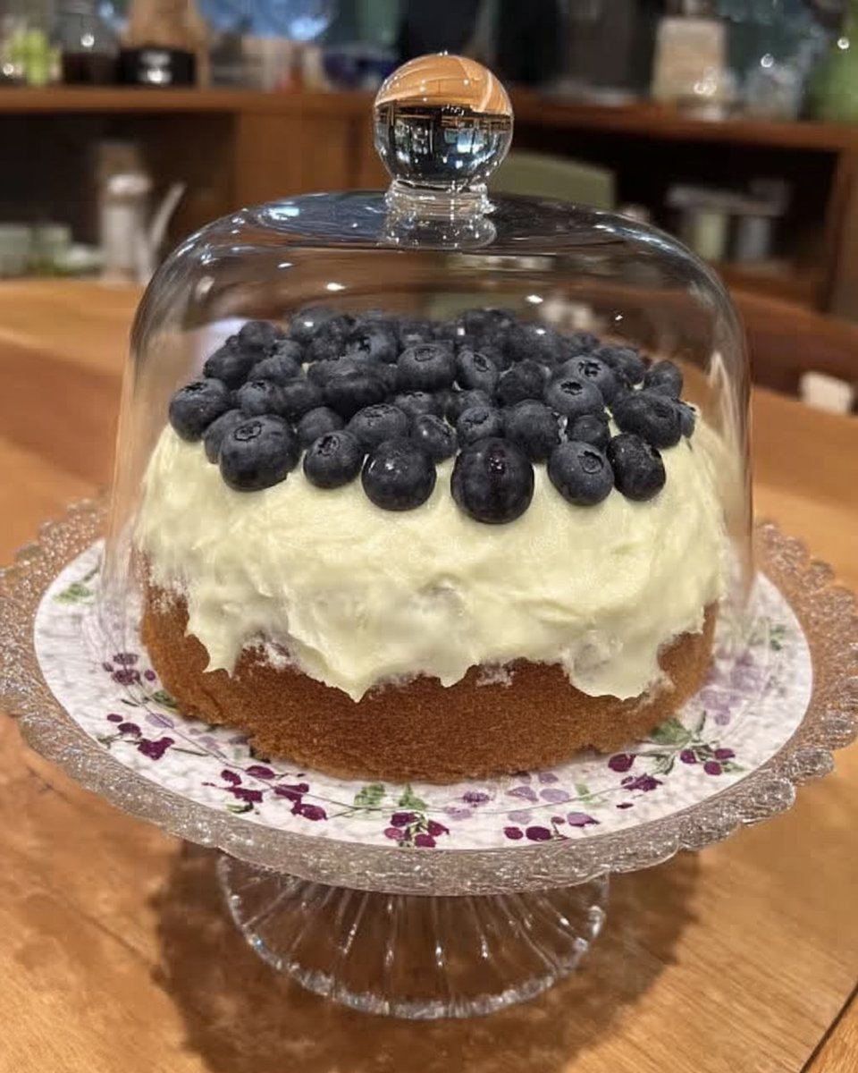Slice of moist lemon blueberry cake on a white plate