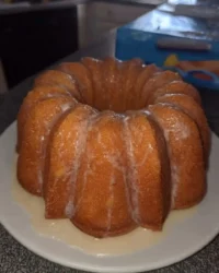 Golden Southern lemon pound cake cooling on a wire rack in a sunlit kitchen
