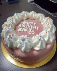 A slice of minimal cake showing a tight tender crumb and smooth buttercream