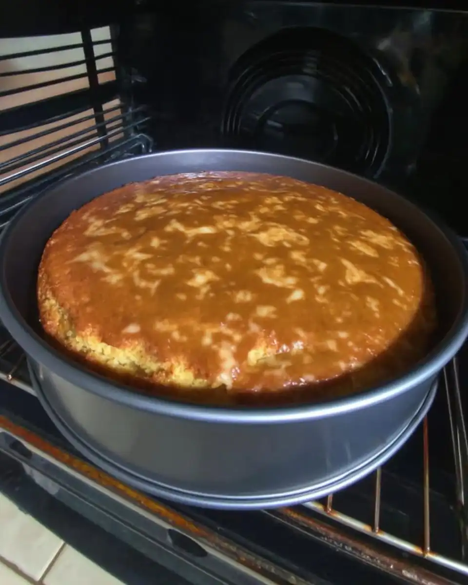 Banana Cake 13 Mixing banana cake batter in a bowl with a spatula