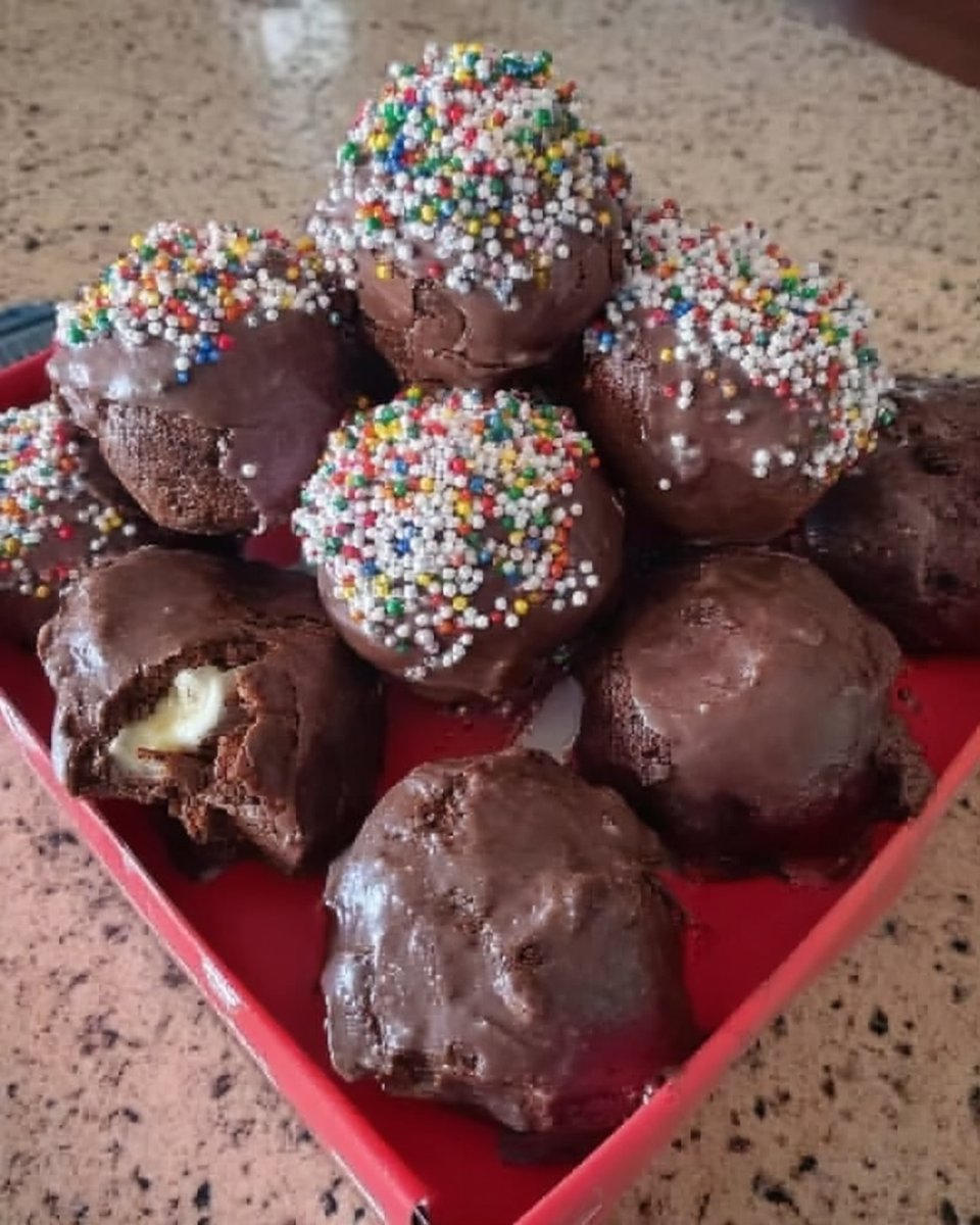 whisking chocolate cake batter in a glass bowl