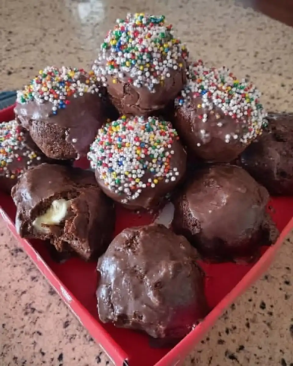 whisking chocolate cake batter in a glass bowl
