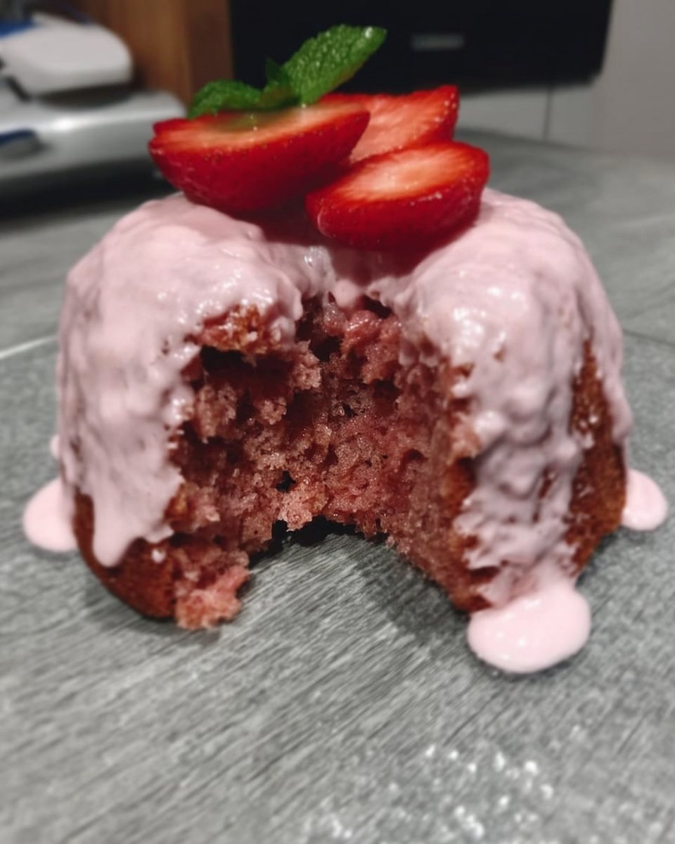 Strawberry Cake 13 Pink strawberry cake batter being mixed in a bowl with a spatula