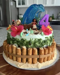 Finished Moana cake with blue ocean frosting and biscuit sand beach