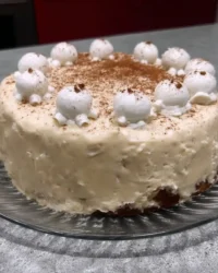 Slice of eggnog cake with ermine frosting and pecan coating