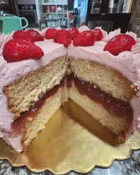 Close up of pink cake strawberry cream cheese frosting swirl