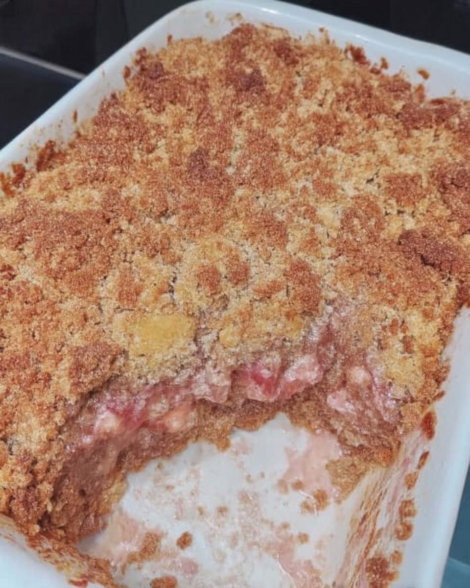 Wooden skewer poking holes in a baked cake with milk glaze being poured