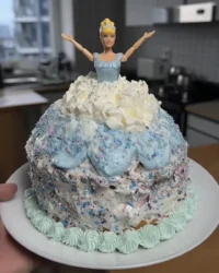 Finished blue princess tsunami cake with doll and sprinkles