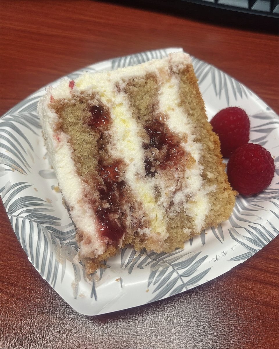 Slice of raspberry white chocolate cake showing fluffy crumb