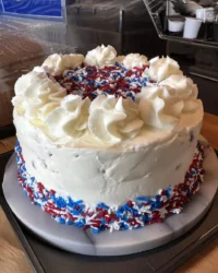 Rustic flag cake topped with fresh blueberries and raspberries