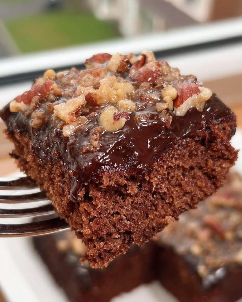 Square of chocolate cake served with a scoop of vanilla ice cream