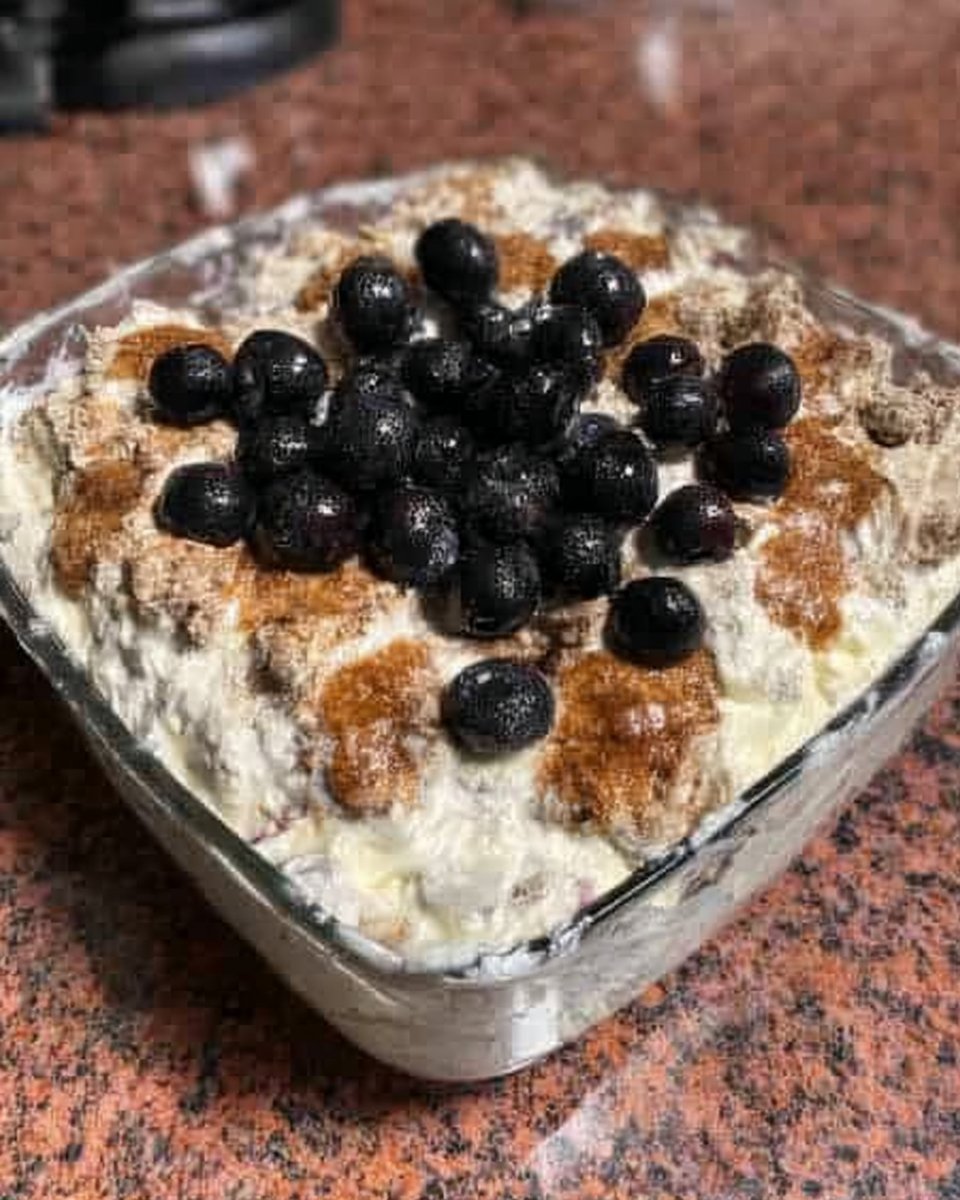 Slice of strawberry icebox cake with visible layers of chocolate pudding and graham crackers