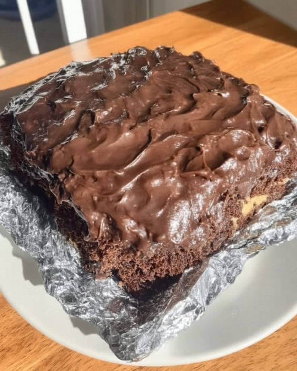 Finished wacky cake in pan dusted with powdered sugar
