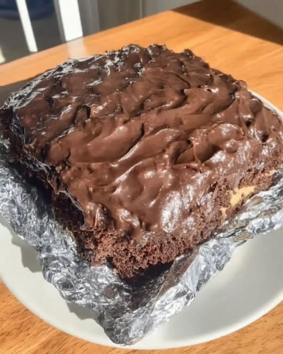 Finished wacky cake in pan dusted with powdered sugar