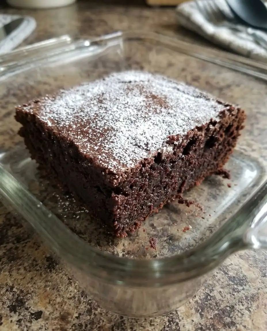 A sliced view of the black forest pastry cake showing distinct layers of cream and cherries.