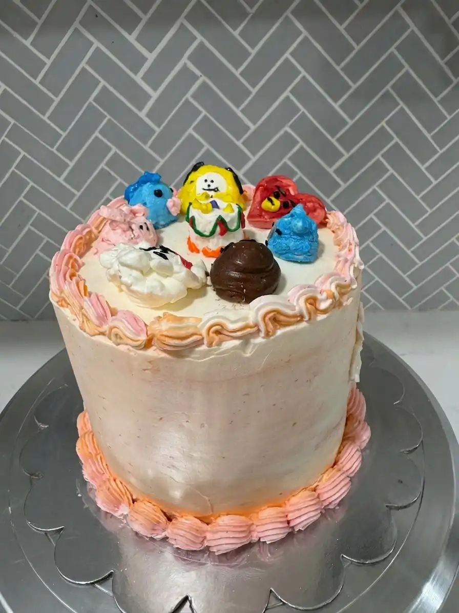 A clean slice of Bts Cake on a white plate showing three even layers