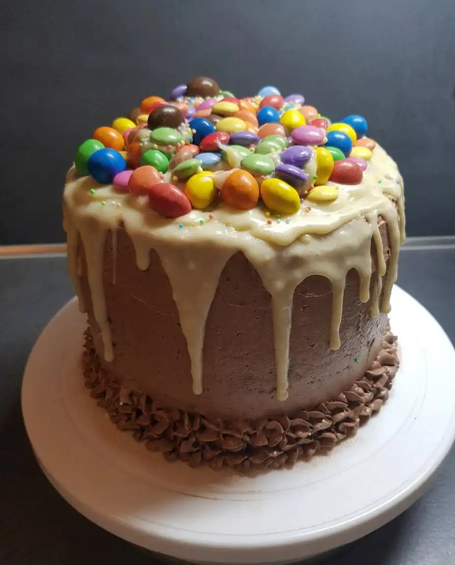 A single slice of candy cake showing the internal layers and candy vault