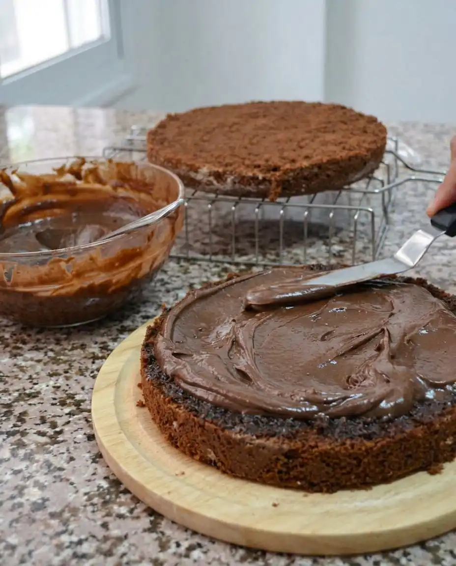 Ingredients for chocolate cake including cocoa powder, spices, and farm fresh eggs on a wooden board