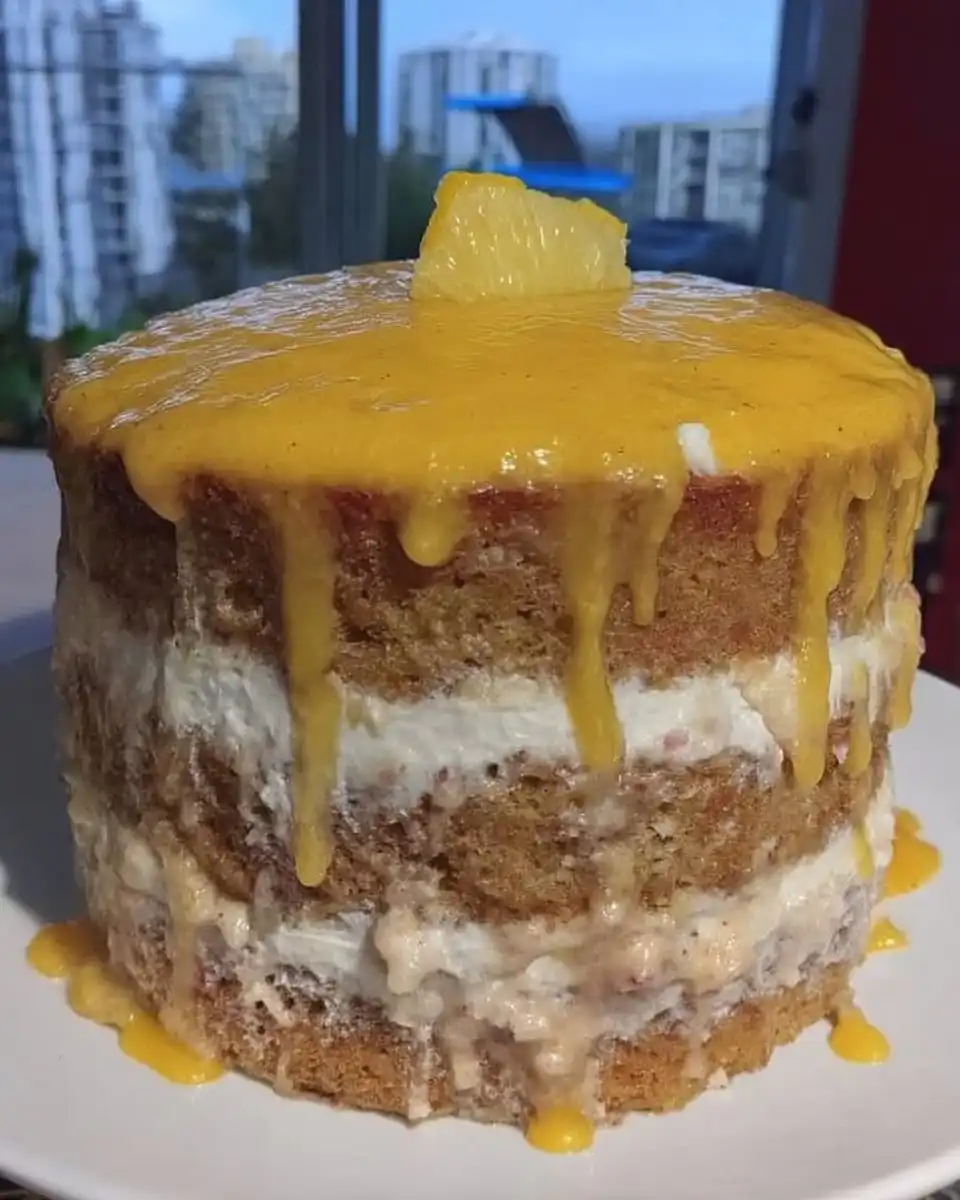 Full Lemon Rainbow Cake 2 presented on a glass stand with citrus garnish.
