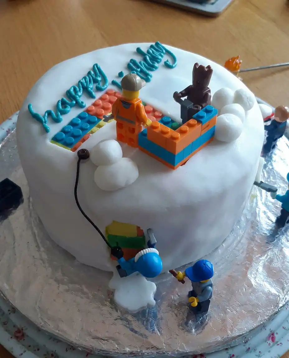Completed boys cake styled as a soccer field with figurines and white lines