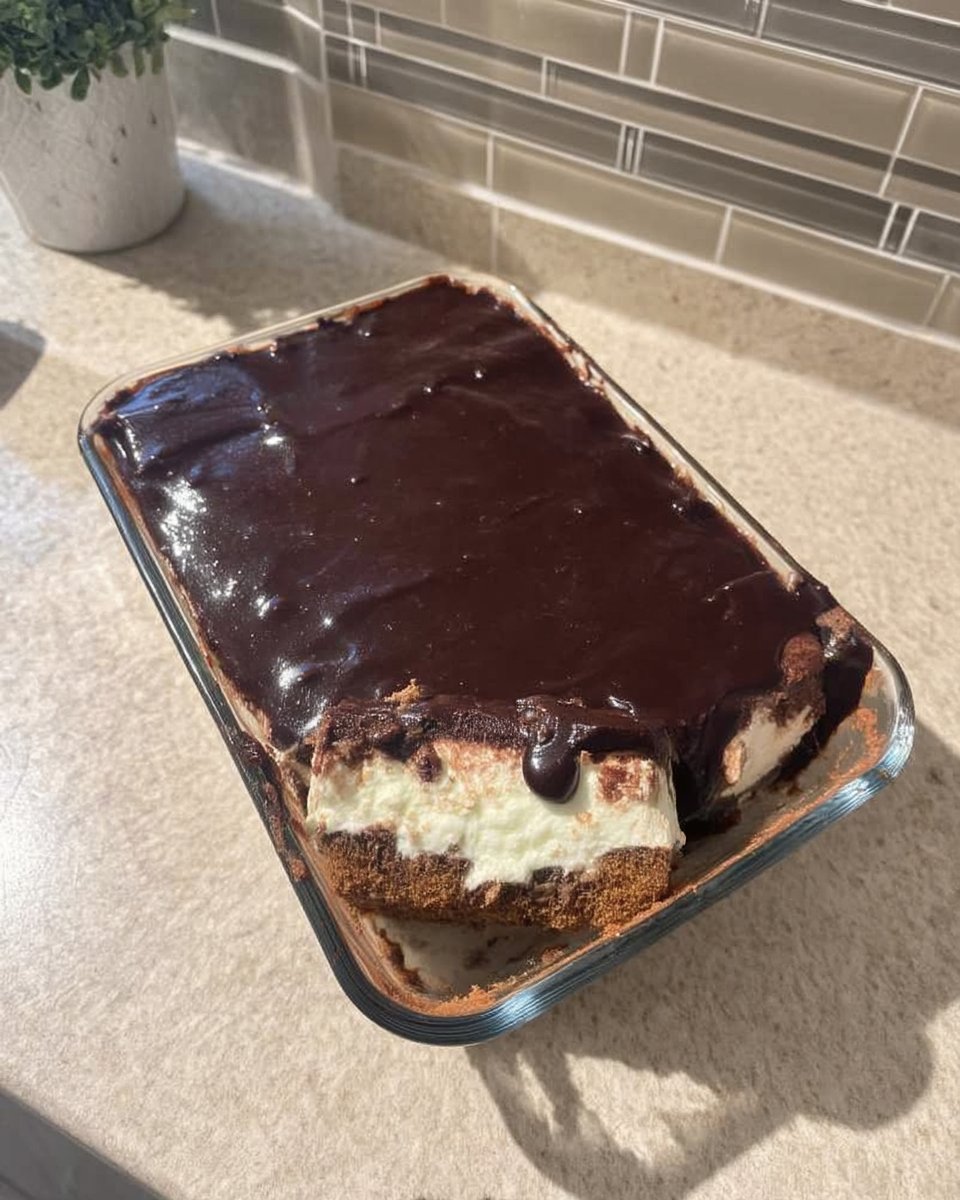 A spatula folding whipped topping into vanilla pudding mixture