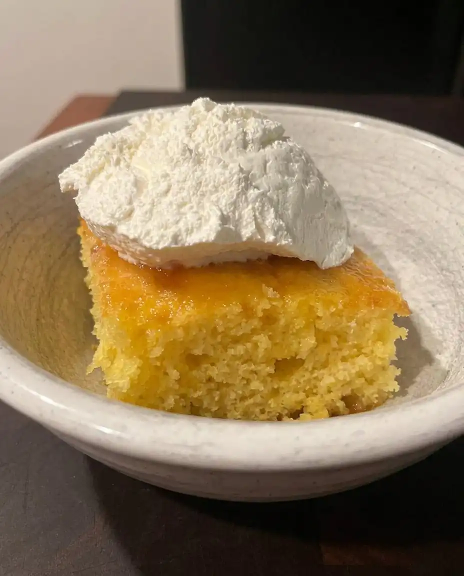 Fresh lemons, eggs, and bowls of sugar and zest on a flour-dusted counter.