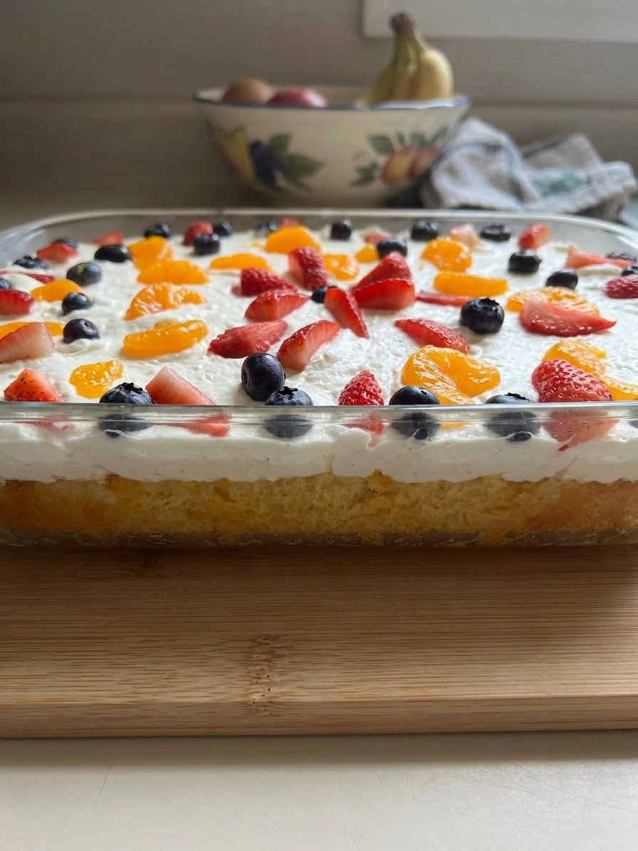 A slice of mandarin orange cake with pineapple frosting on a plate