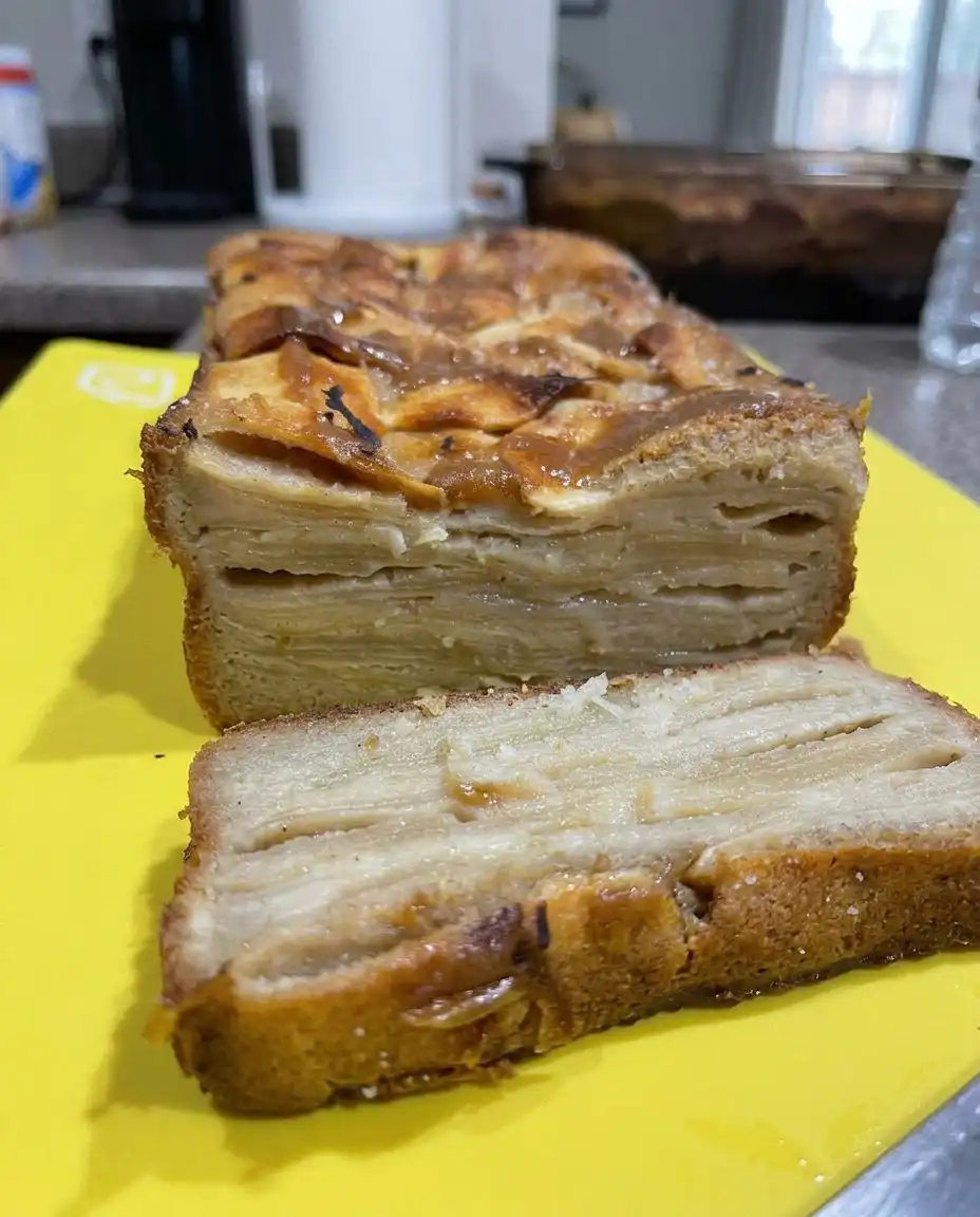 Apple Dump Cake 13 Thin slices of yellow butter arranged evenly over a layer of dry spice cake mix.