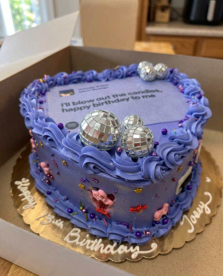 Olivia Rodrigo cake served on a wooden cake stand