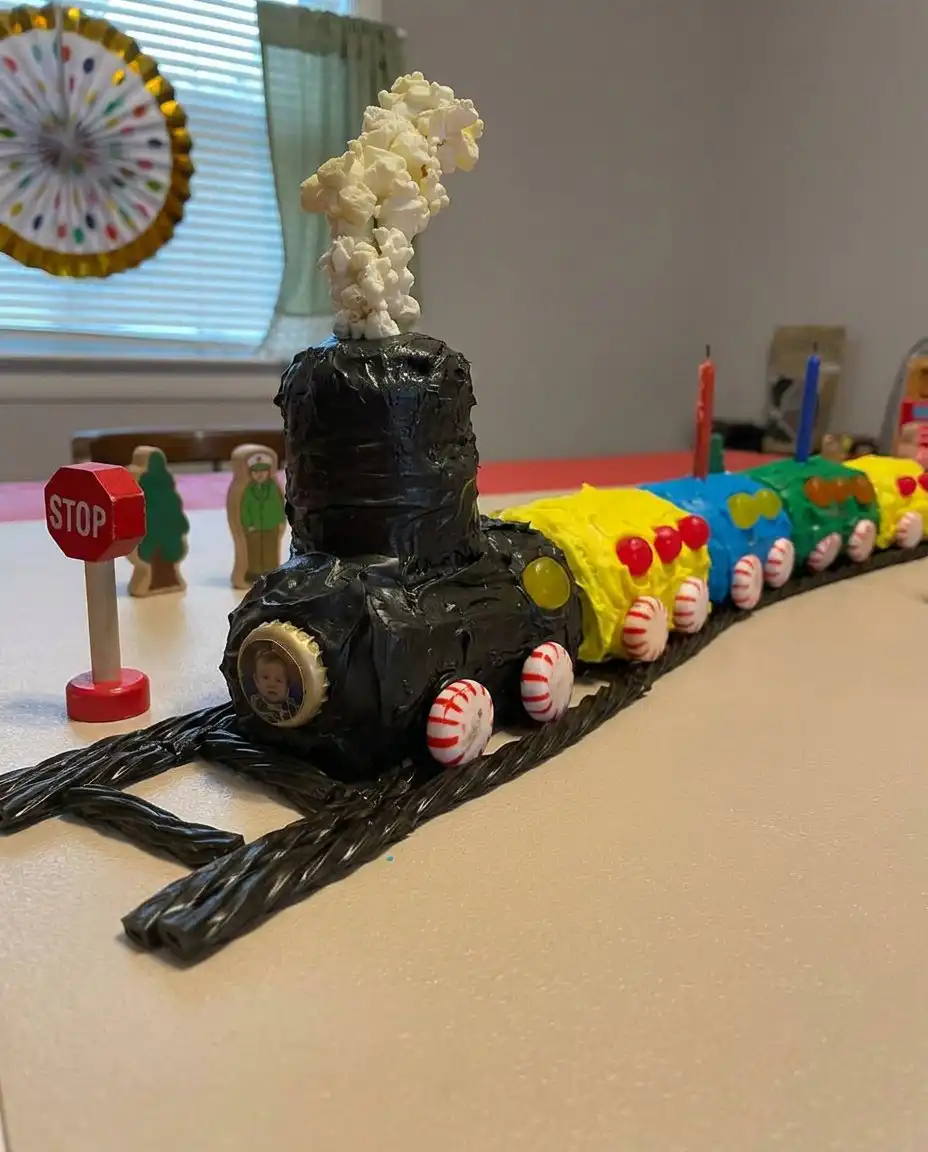 Hand piping buttercream details onto a train cake using Tip 5