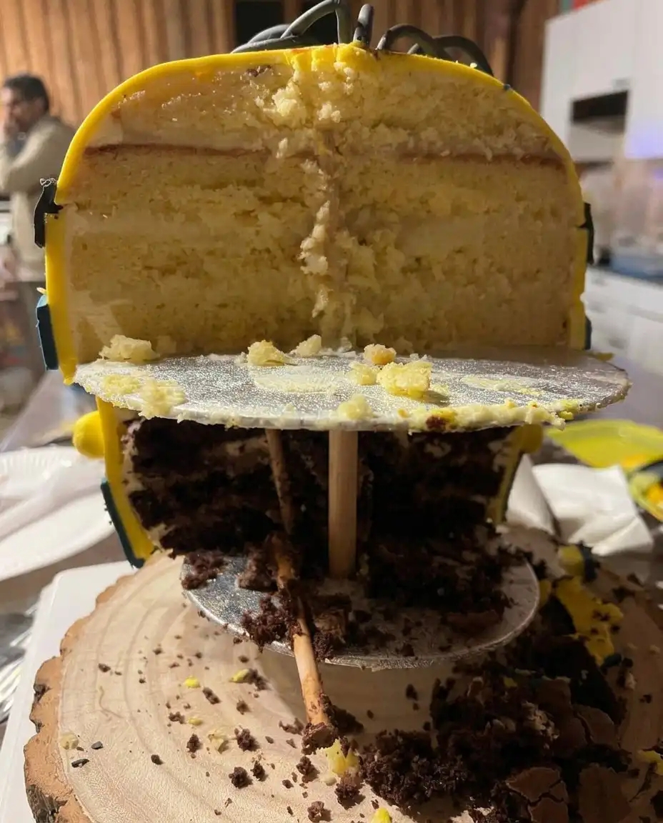 Professional technique for smoothing yellow frosting on a minion cake