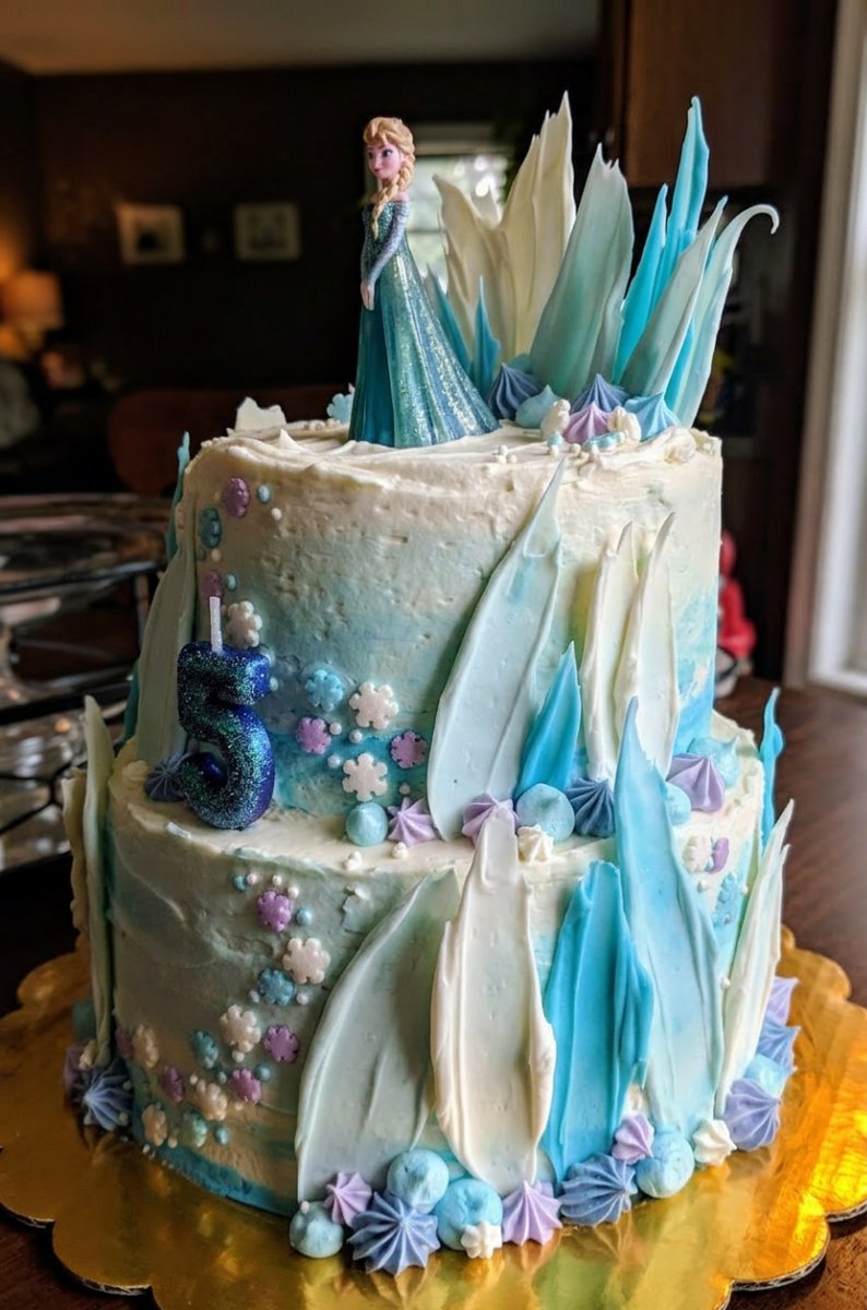 Frozen Cake 13 Hands carefully shaping a small fondant Olaf figure