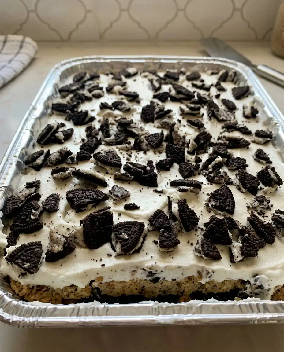 A wedge of cookie cake served with a dollop of whipped cream on a vintage plate
