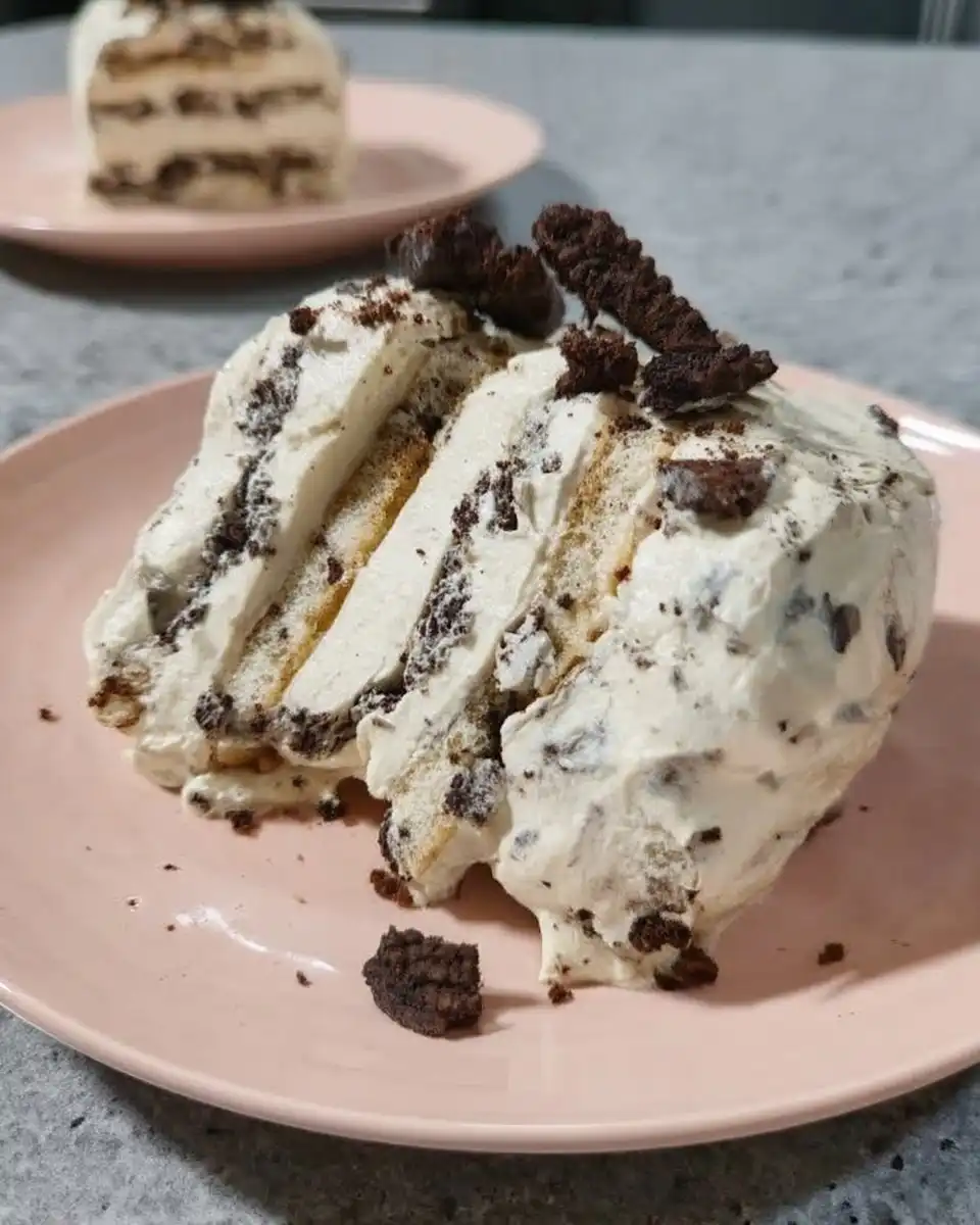 A clean slice of Oreo icebox cake showing distinct black and white layers