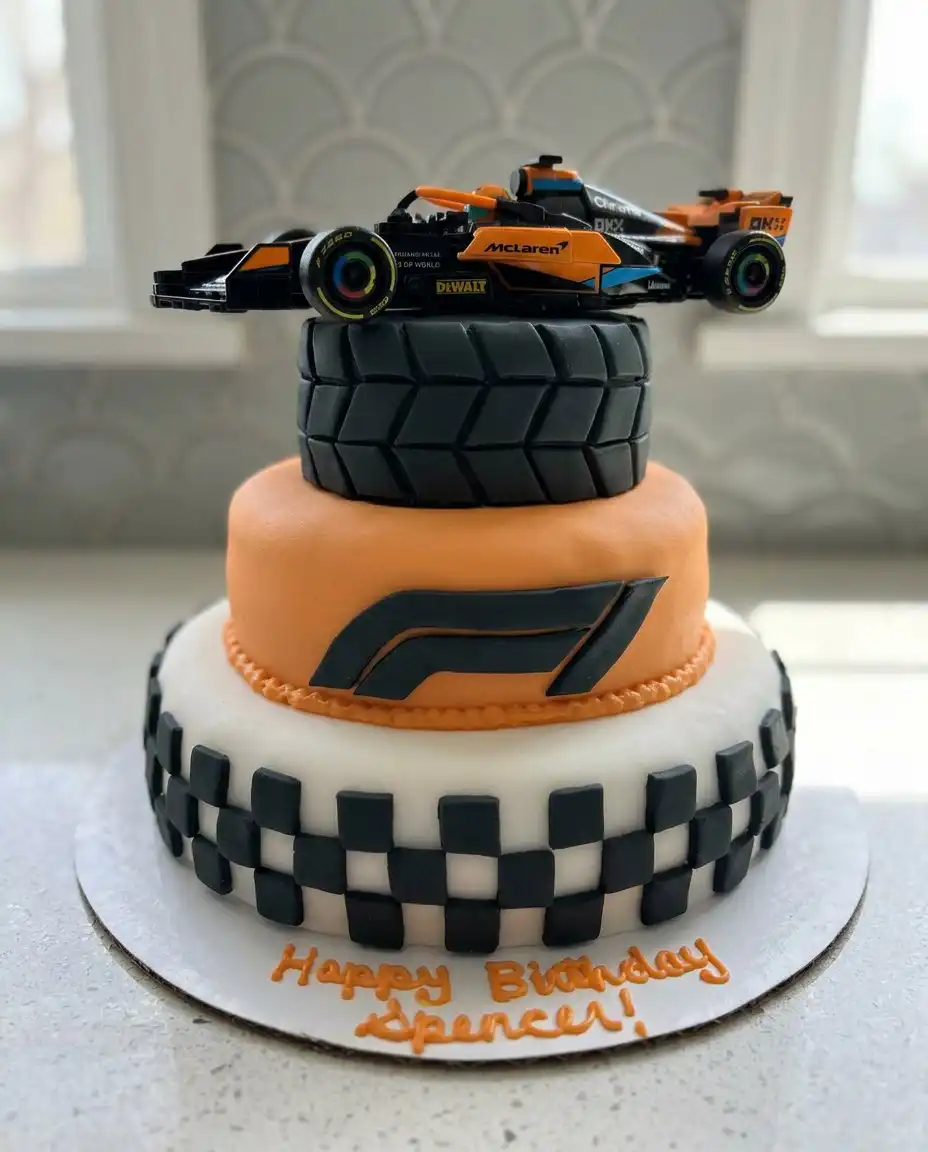 A slice of F1 cake being served on a plate next to the decorated car cake.