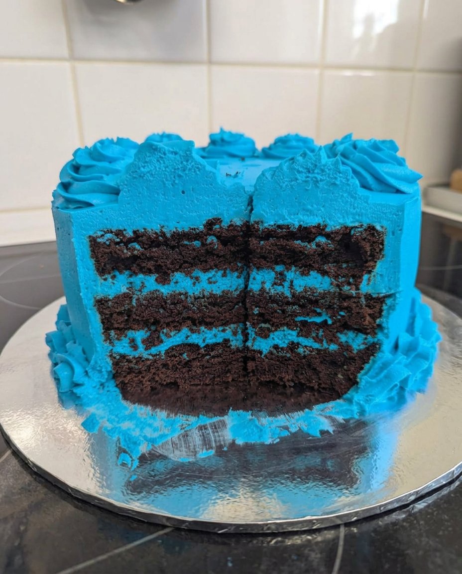 Stitch Cake 13 Glossy white Swiss meringue buttercream being lifted by a mixer whisk.