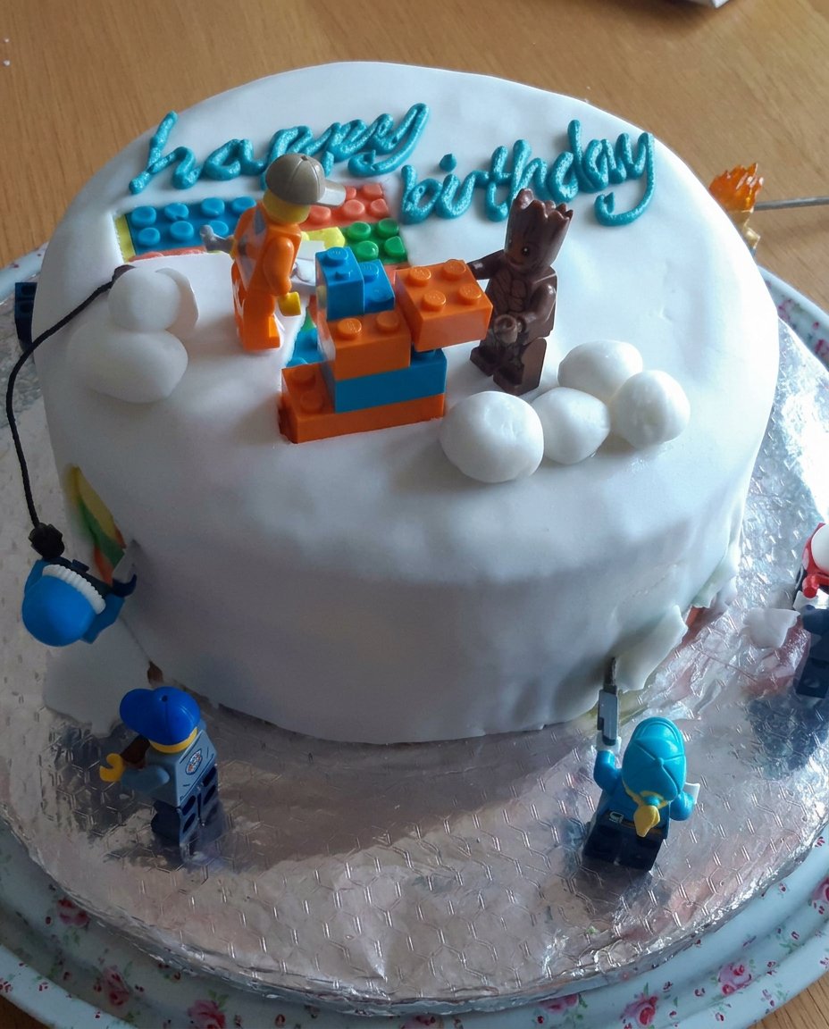 A rectangular butter cake cooling on a wire rack for a soccer pitch design