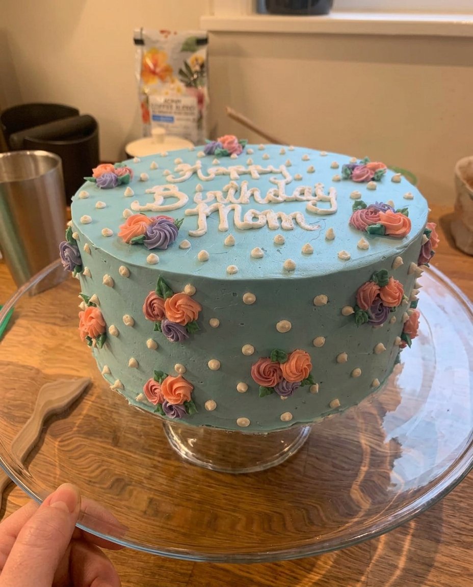 Happy Birthday Mom Cake 13 Close up of a 9 inch tapered spatula forming a white rose petal on a cake.