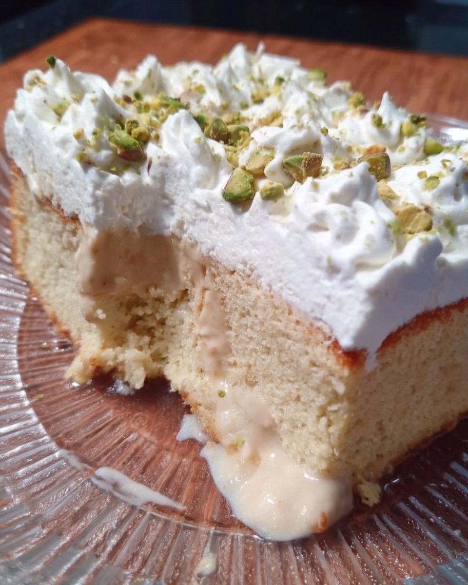 A full 9x13 tray of Tres Leches cake with whipped cream and cinnamon