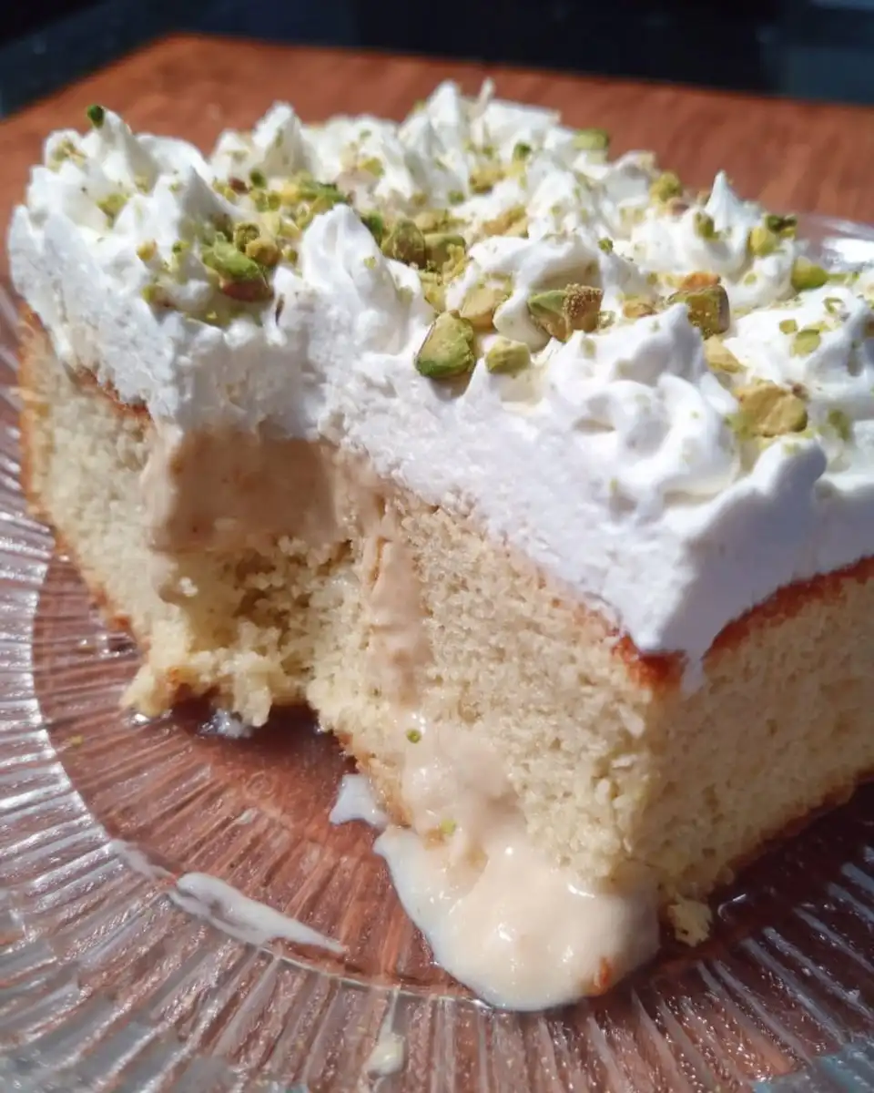 A full 9x13 tray of Tres Leches cake with whipped cream and cinnamon