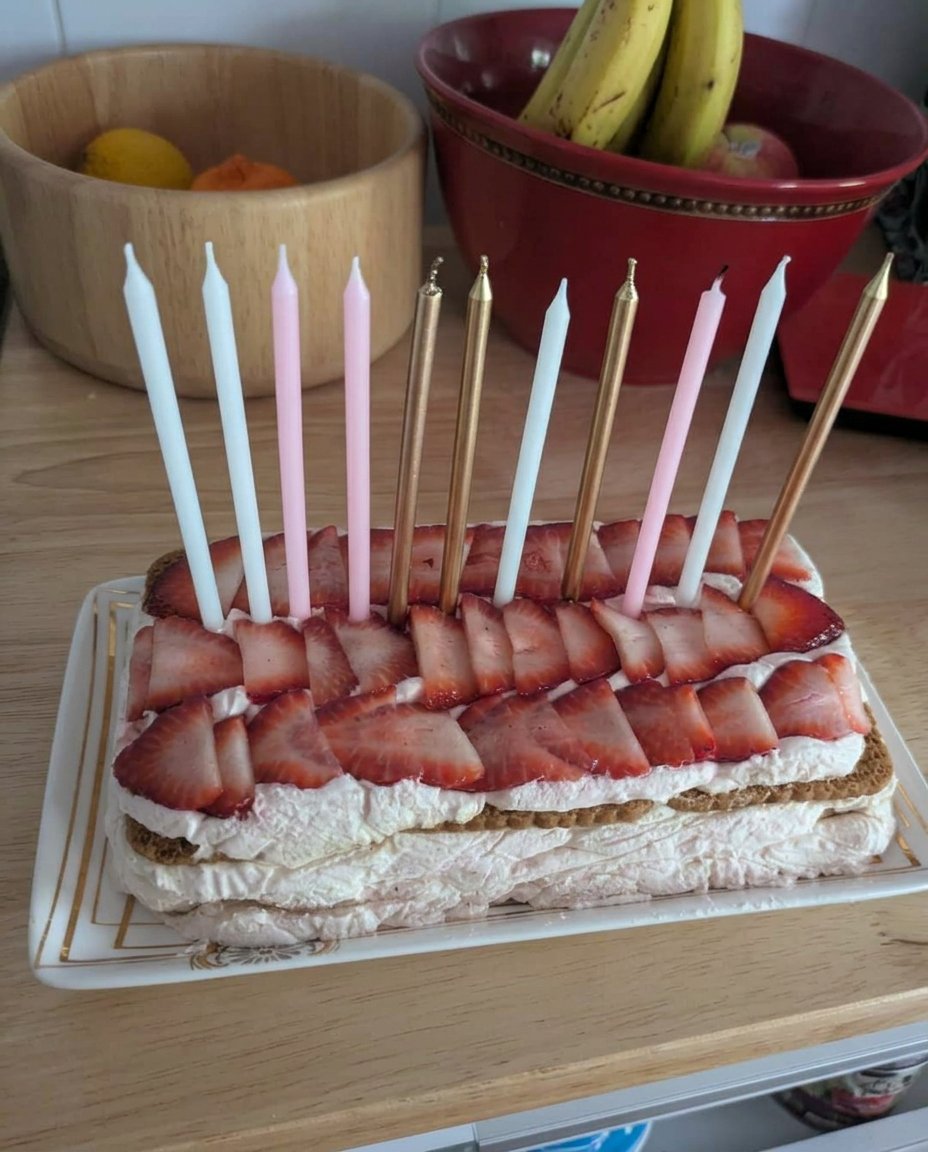 Heavy cream being whipped into stiff peaks in a chilled silver bowl.