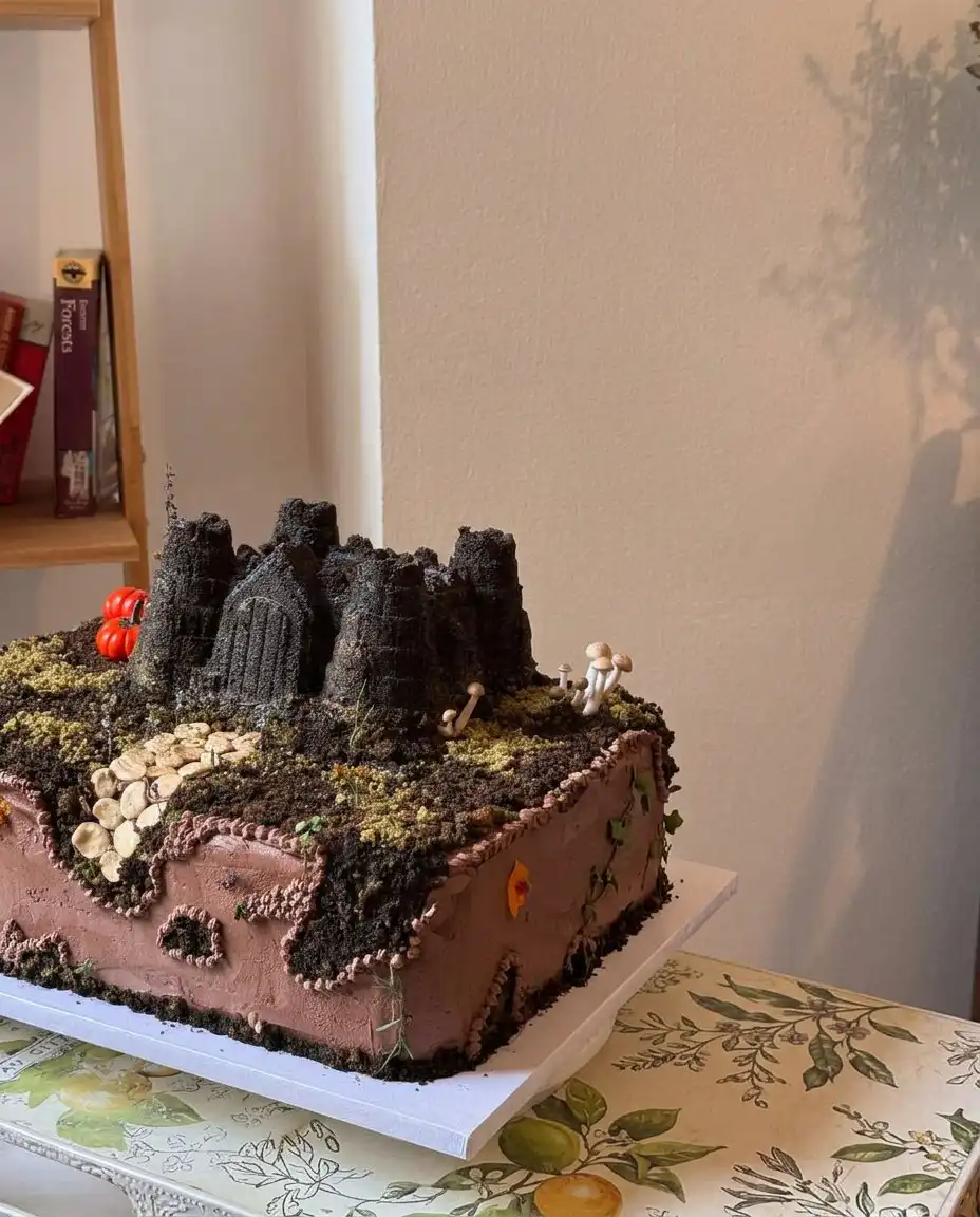 The completed castle cake with green coconut grass and figurines