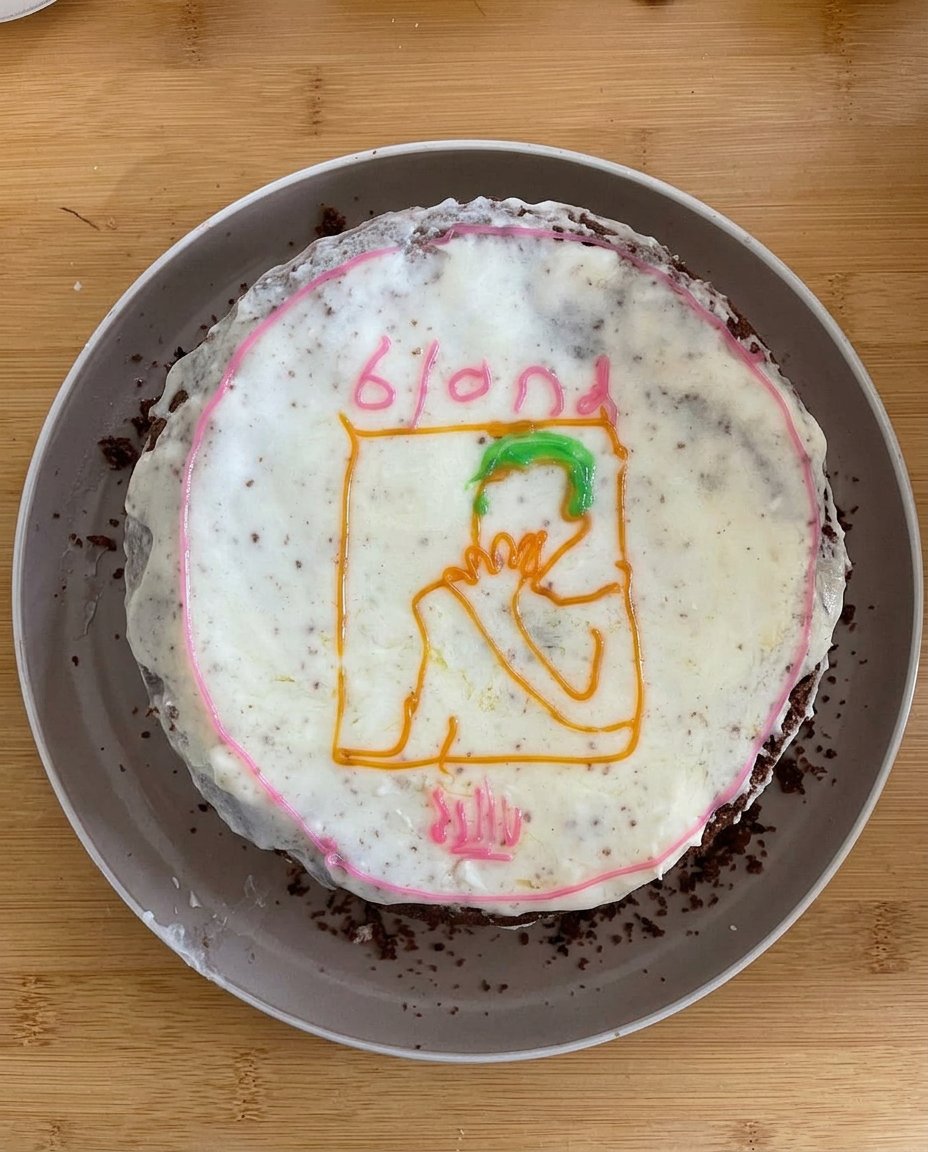 A completed Frank Ocean Cake with a blue gummy ocean and modeling chocolate palm trees